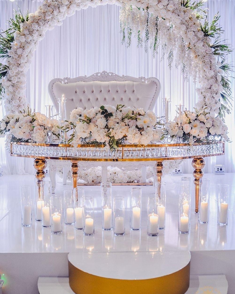 Floral ceremony arch framing an aisle set for a wedding