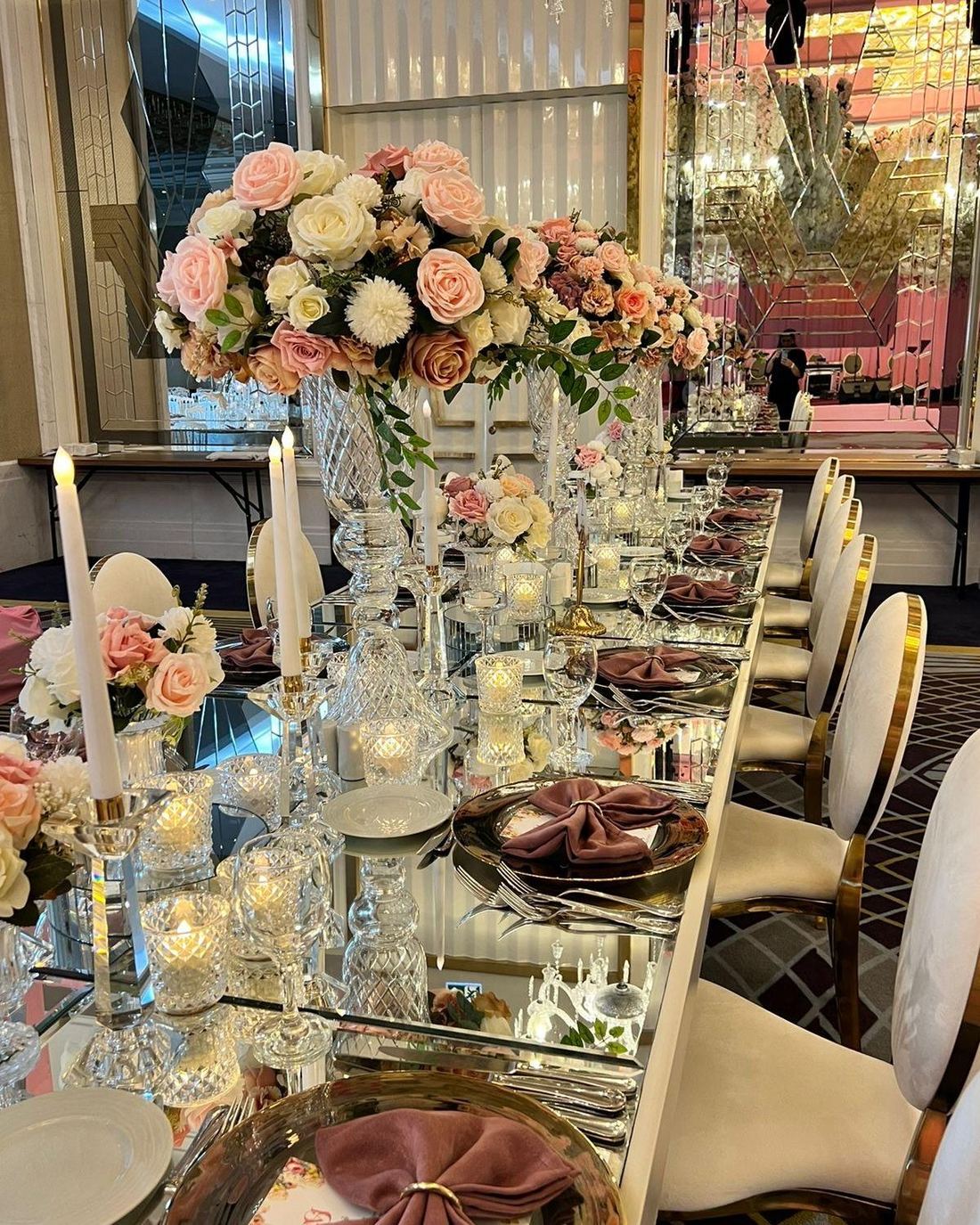 Blush and gold reception table with tall floral centrepieces