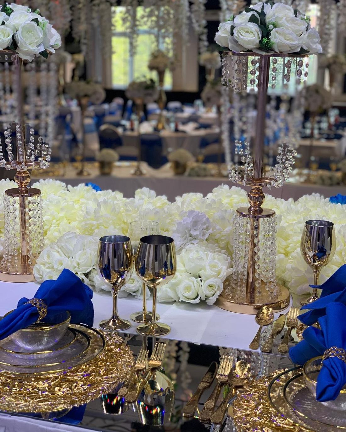 Royal blue and gold table setting with crystal centrepieces